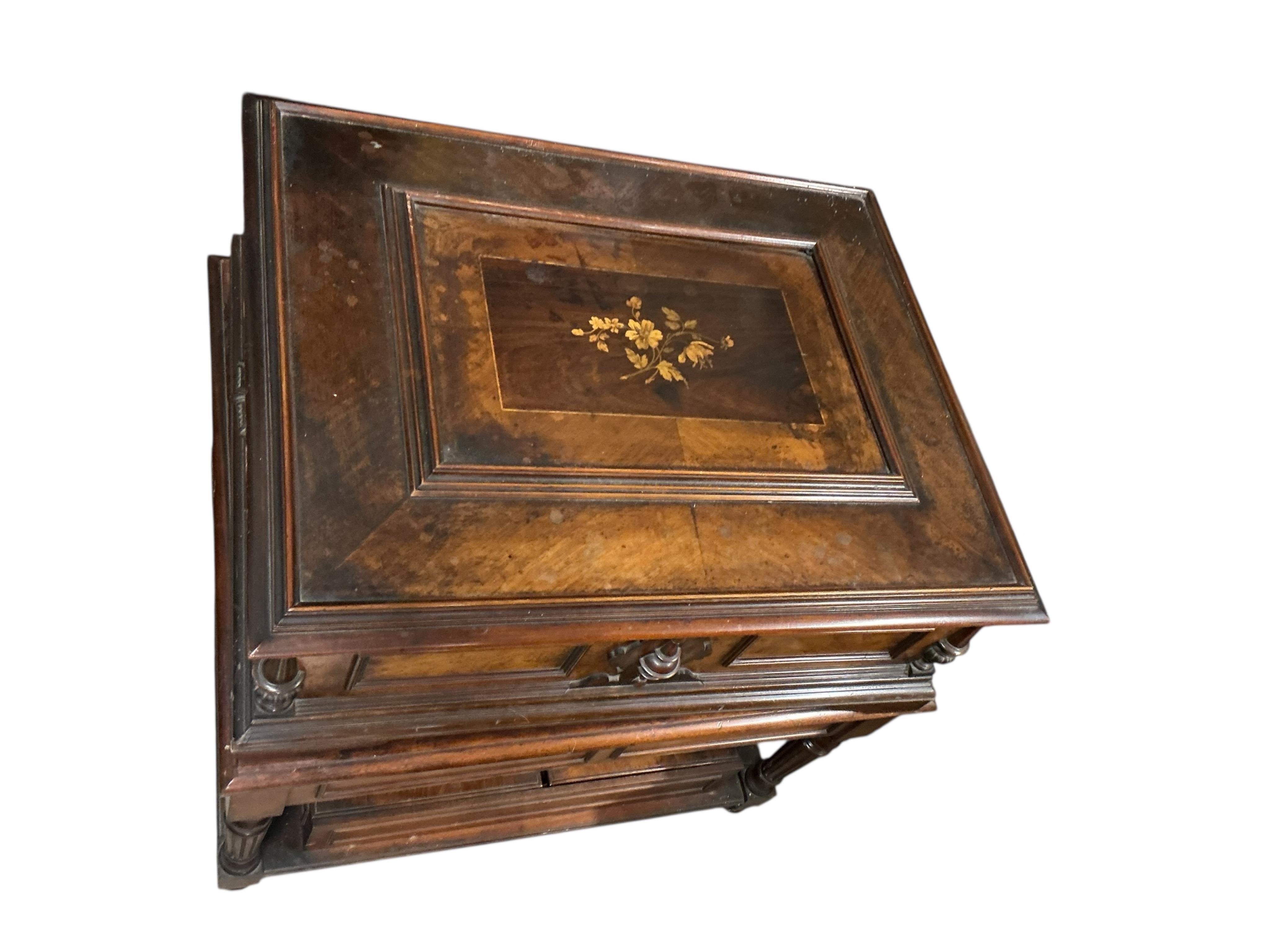A substantial early 20th century inlaid walnut cased tabletop Orpheus polyphon on a floor standing base containing a compartment for storing the discs, together with thirty-seven 57.5cm diameter discs, and a winding hand